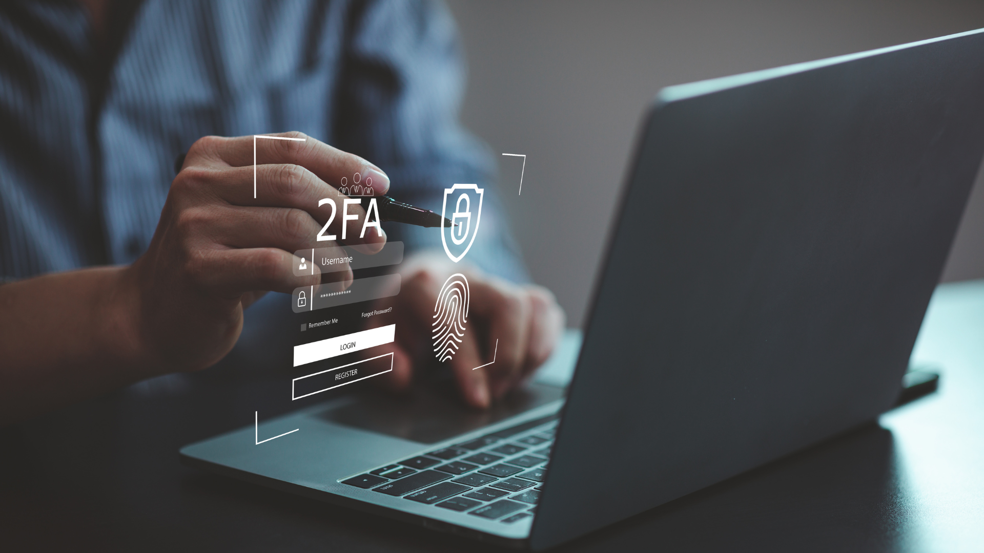 Hands on a laptop with cybersecurity icons floating about